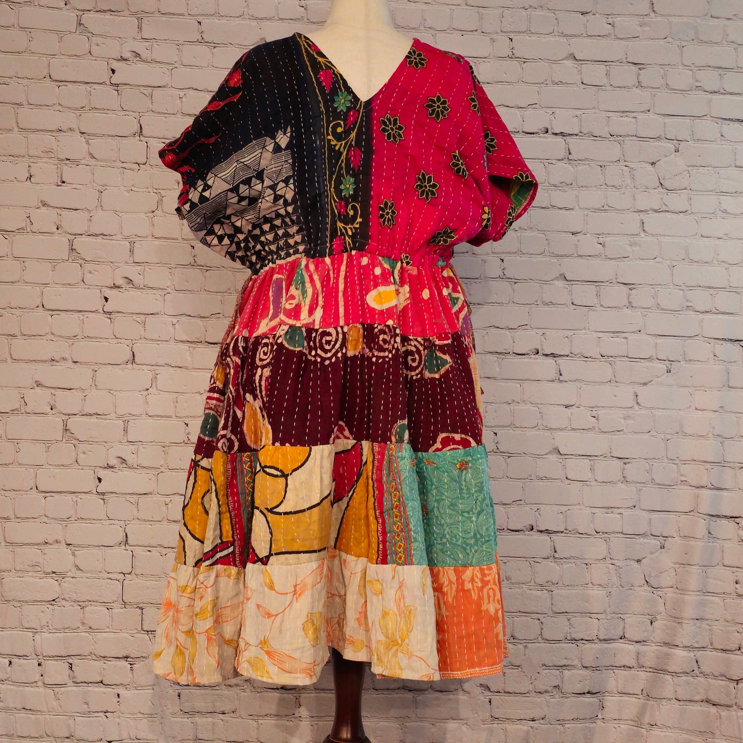 Twillow Midnight Bloom Kantha Midi Dress with pink and black floral bodice and multicolor patchwork skirt featuring Kantha stitching detail.