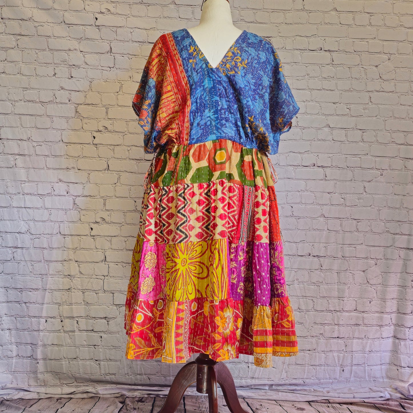 Twillow Ocean Sunrise Kantha Midi Dress featuring a blue bodice and bright multicolor patchwork skirt with Kantha stitching detail.