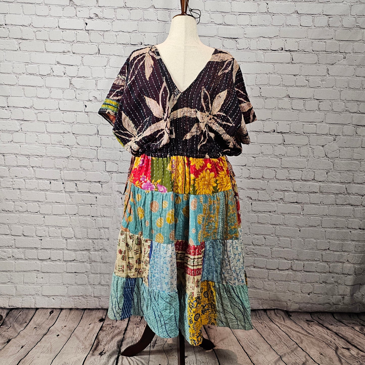 Black palm-print Twillow Kantha Midi Dress with a colorful boho patchwork skirt in yellow, blue, aqua, red, and multicolor panels featuring Kantha stitching.