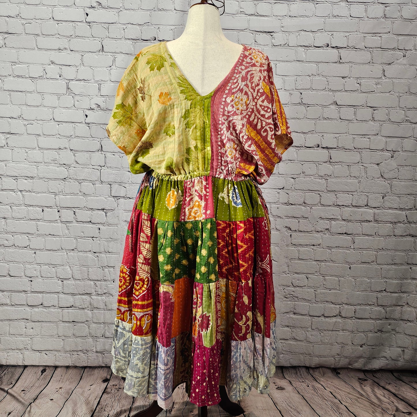 Pink and sage patchwork Twillow Kantha Midi Dress with a multicolor skirt in yellow, purple, magenta, orange, and blue, finished with Kantha stitching.