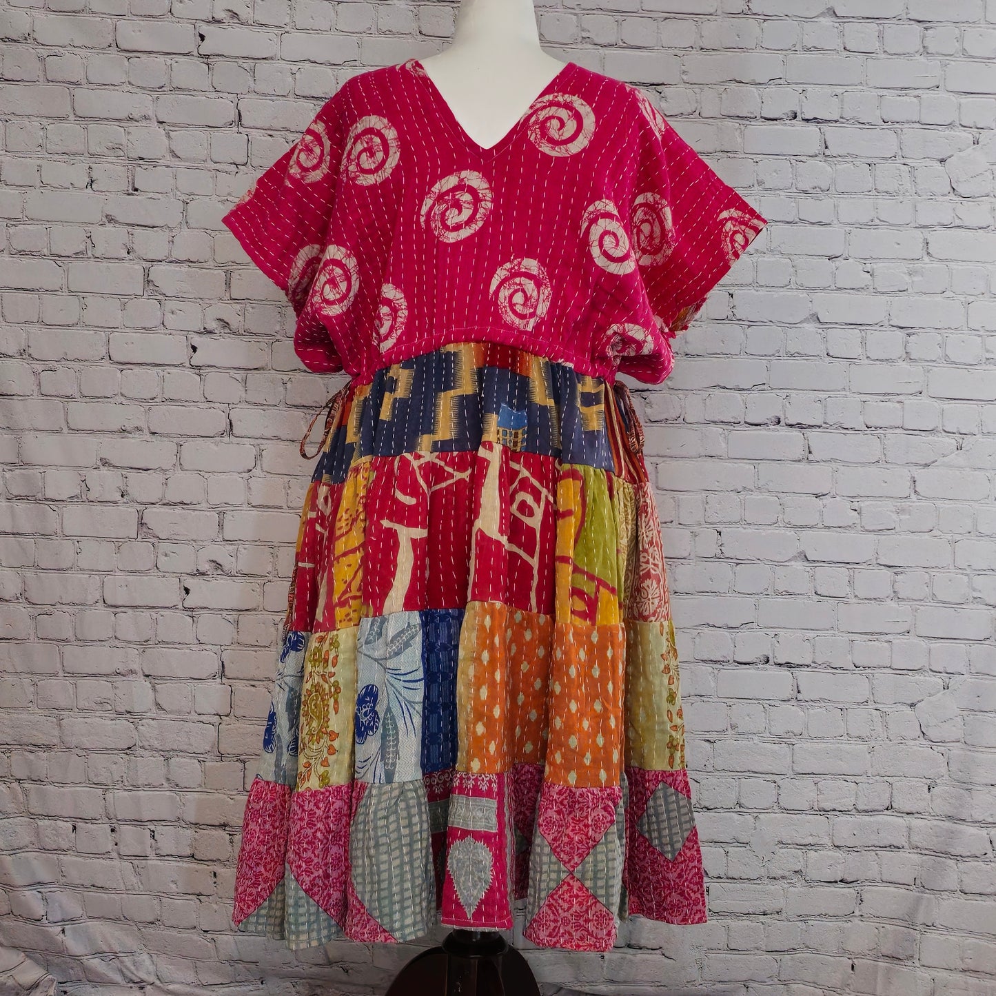 Twillow Fuchsia Bloom Kantha Midi Dress with bright pink swirl-patterned top and multicolor patchwork skirt featuring Kantha stitching.