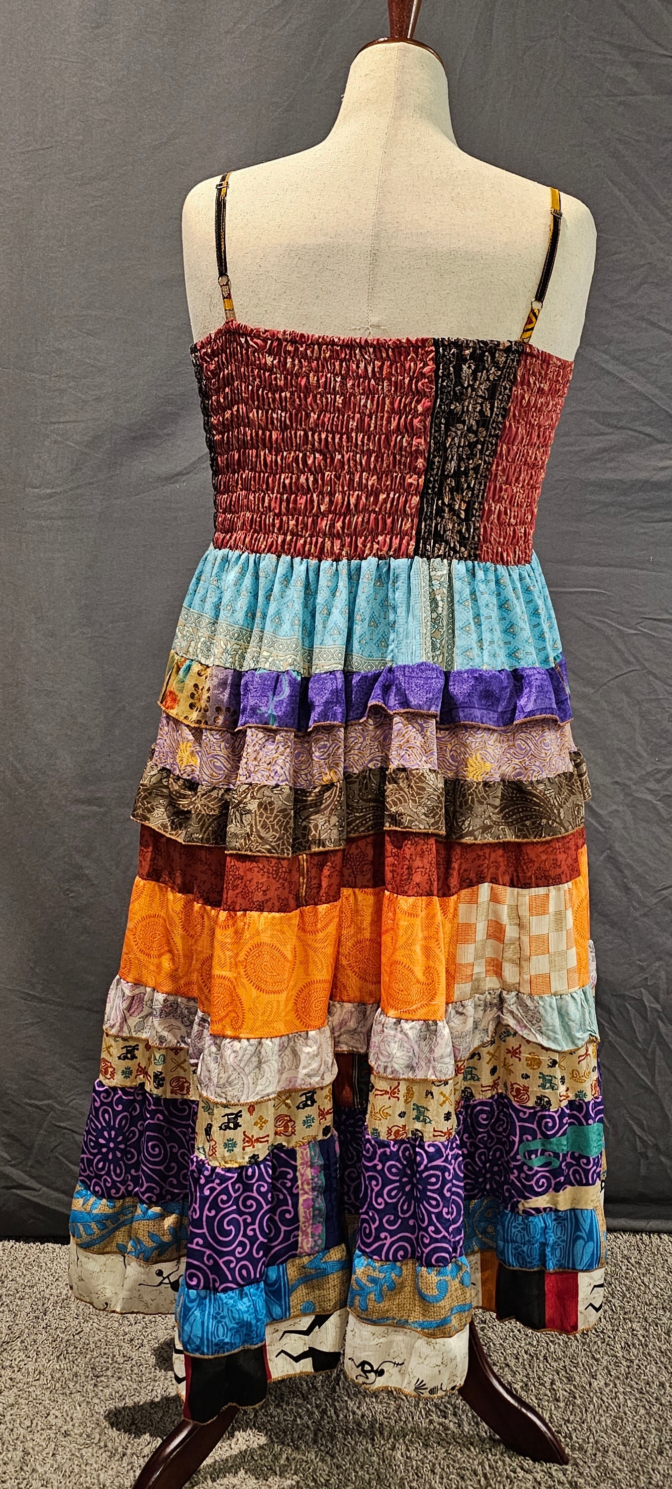 Meadowlark boho patchwork tiered dress in maroon, orange, and blue, one-of-a-kind sustainable fashion.
