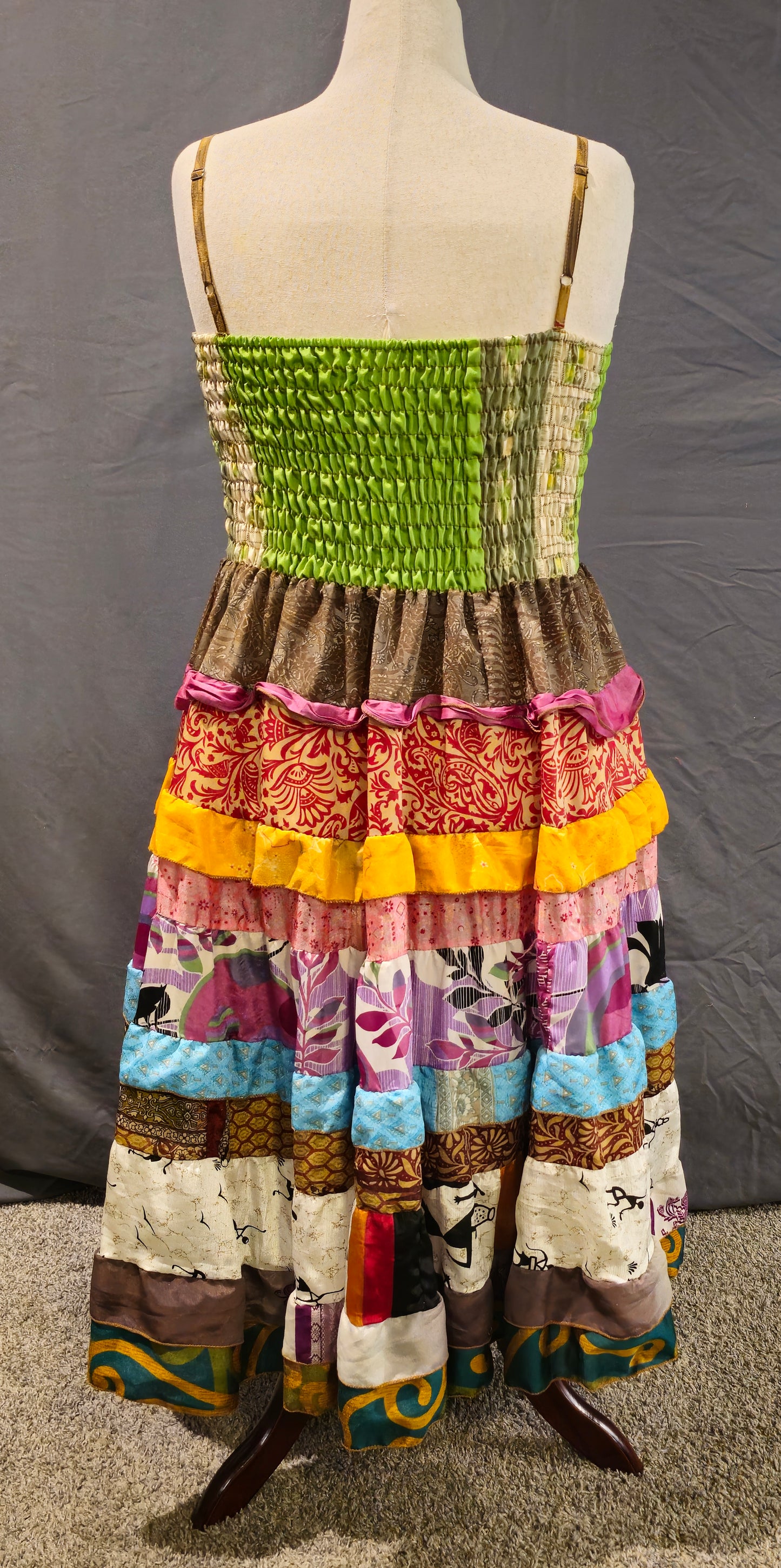 Meadowlark boho patchwork tiered dress in green, gold, pink, and blue, one-of-a-kind sustainable fashion.