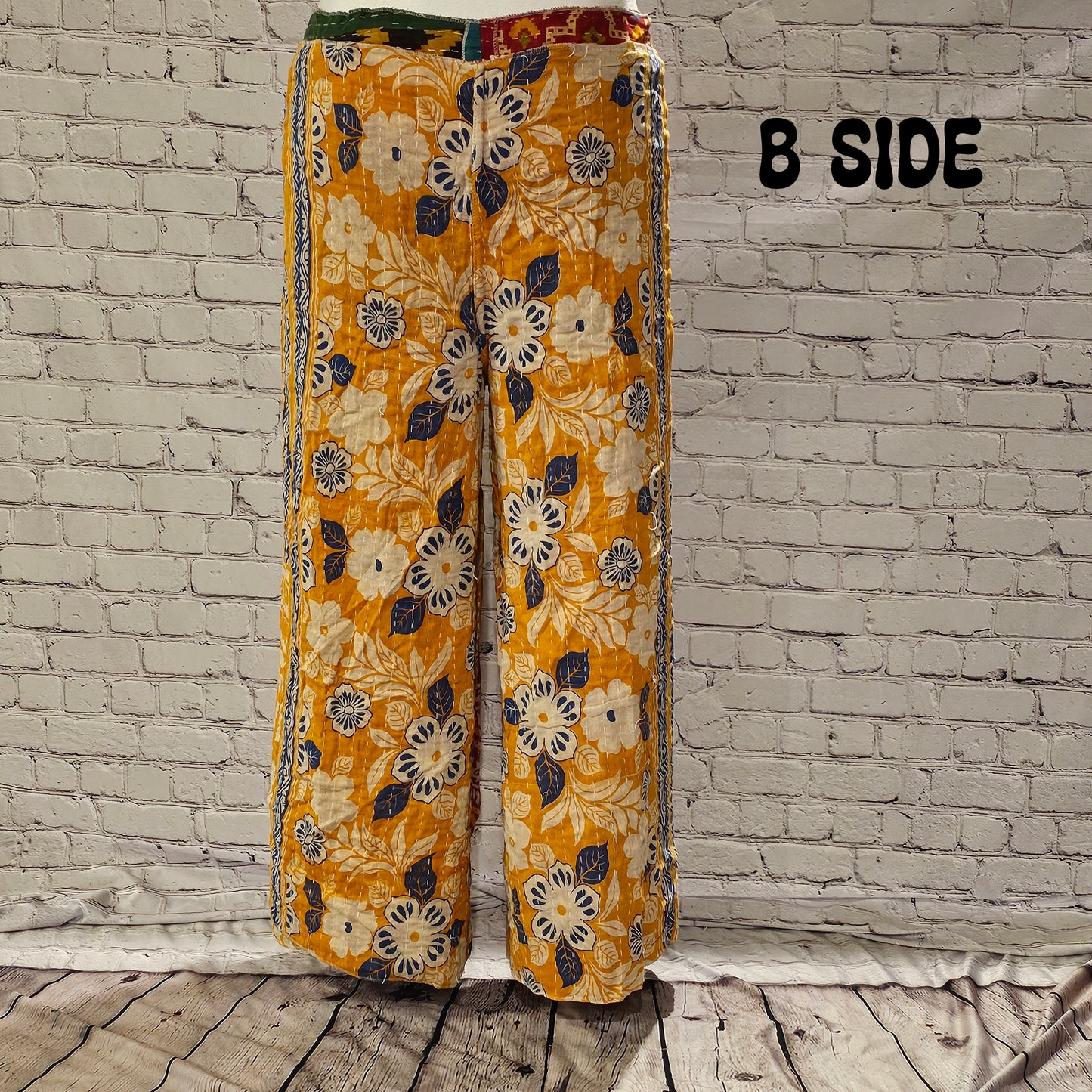 Front view of Ronin Kantha unisex wrap pants, made from recycled sari fabric in boho patchwork design.
