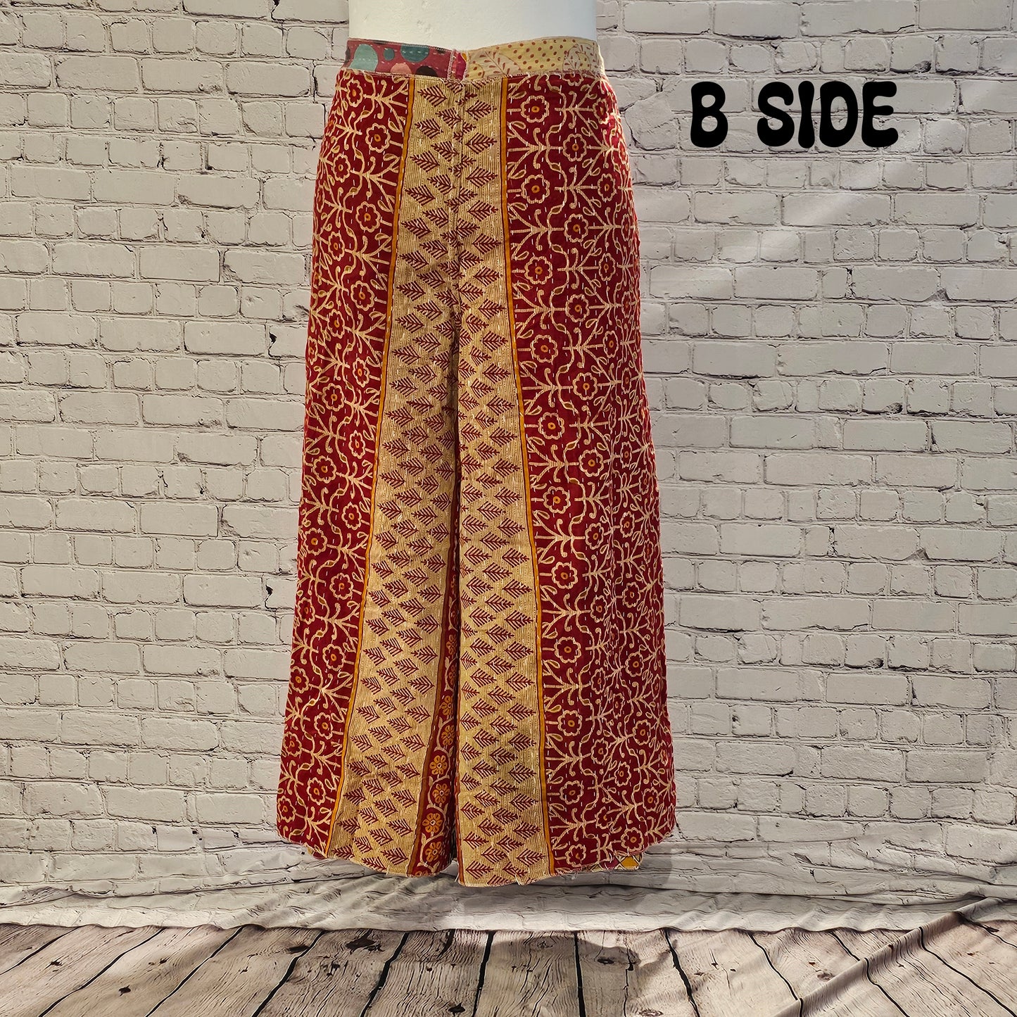 Front view of Ronin Kantha unisex wrap pants, made from recycled sari fabric in boho patchwork design.