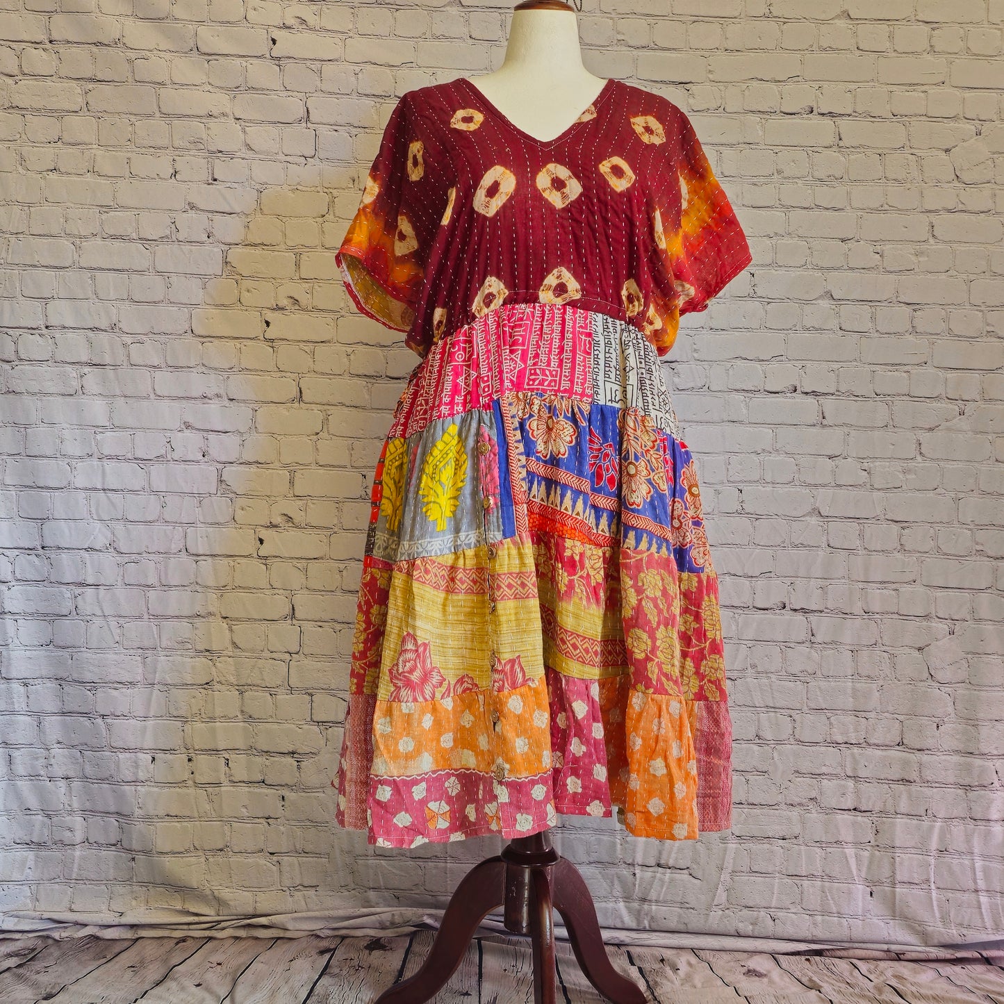 Twillow Sunset Reverie Kantha Midi Dress featuring maroon and multicolor boho patchwork panels, V-neck, and Kantha stitching accents.