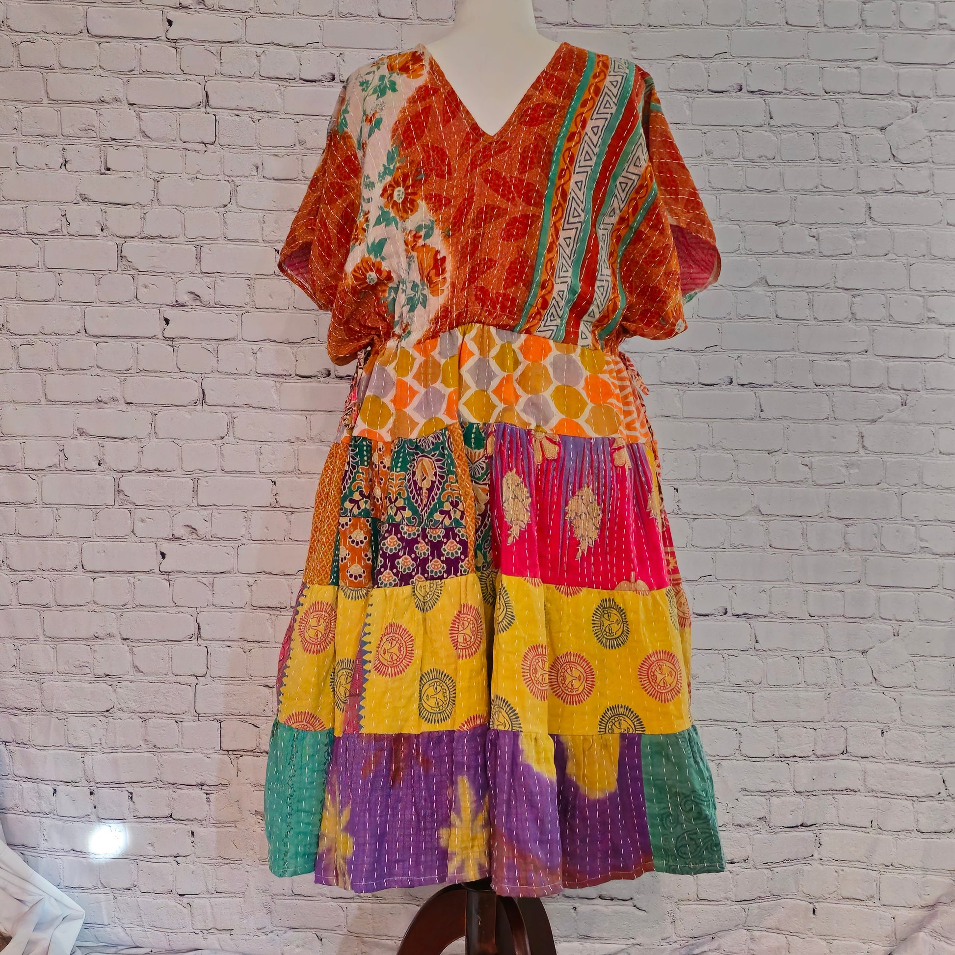 Twillow Marigold Muse Kantha Midi Dress with orange, yellow, and pink patchwork panels featuring Kantha stitching and boho V-neck design.