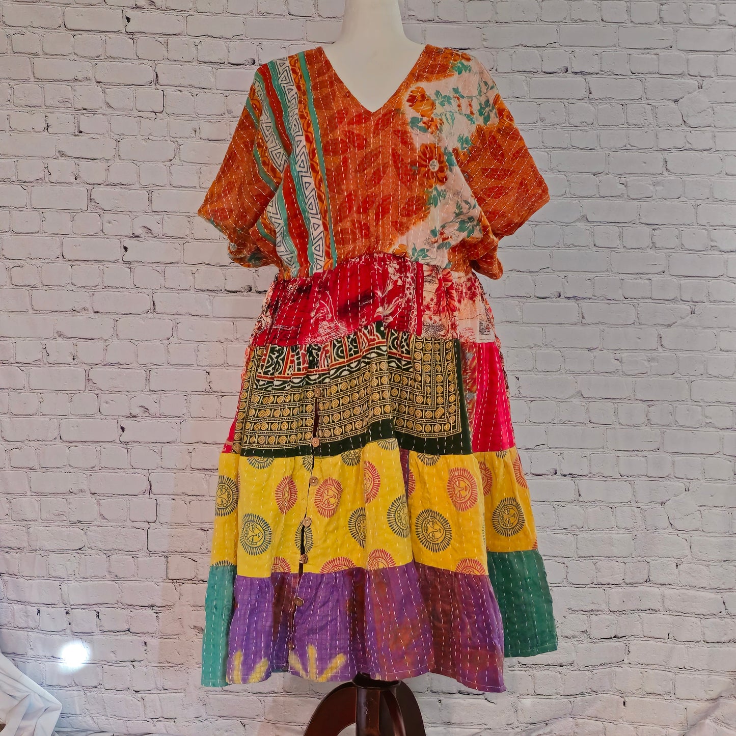 Twillow Marigold Muse Kantha Midi Dress with orange, yellow, and pink patchwork panels featuring Kantha stitching and boho V-neck design.
