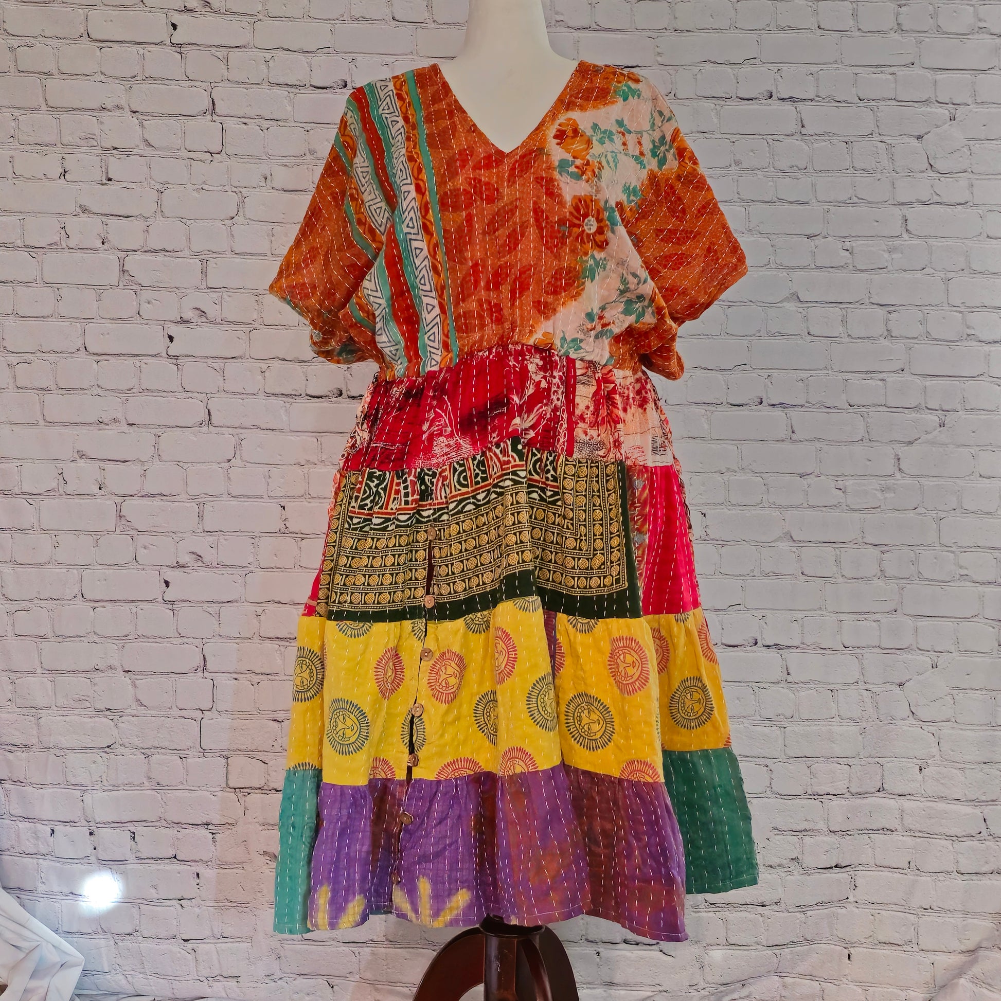 Twillow Marigold Muse Kantha Midi Dress with orange, yellow, and pink patchwork panels featuring Kantha stitching and boho V-neck design.