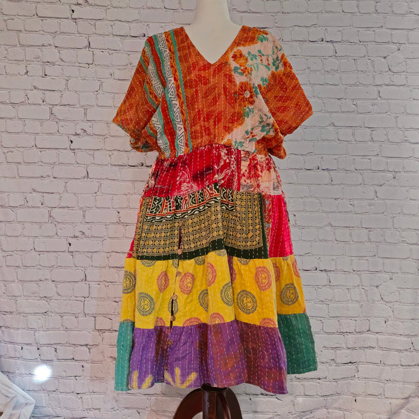 Twillow Marigold Muse Kantha Midi Dress with orange, yellow, and pink patchwork panels featuring Kantha stitching and boho V-neck design.