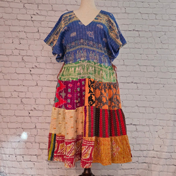 Twillow Indigo Dawn Kantha Midi Dress featuring a blue patterned bodice and colorful patchwork skirt with Kantha stitching detail.