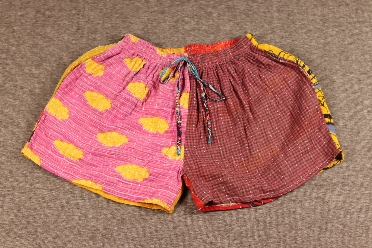 Unisex Kantha shorts with pink and yellow cotton and red gingham panels, detailed with Kantha stitching and a drawstring waist.
