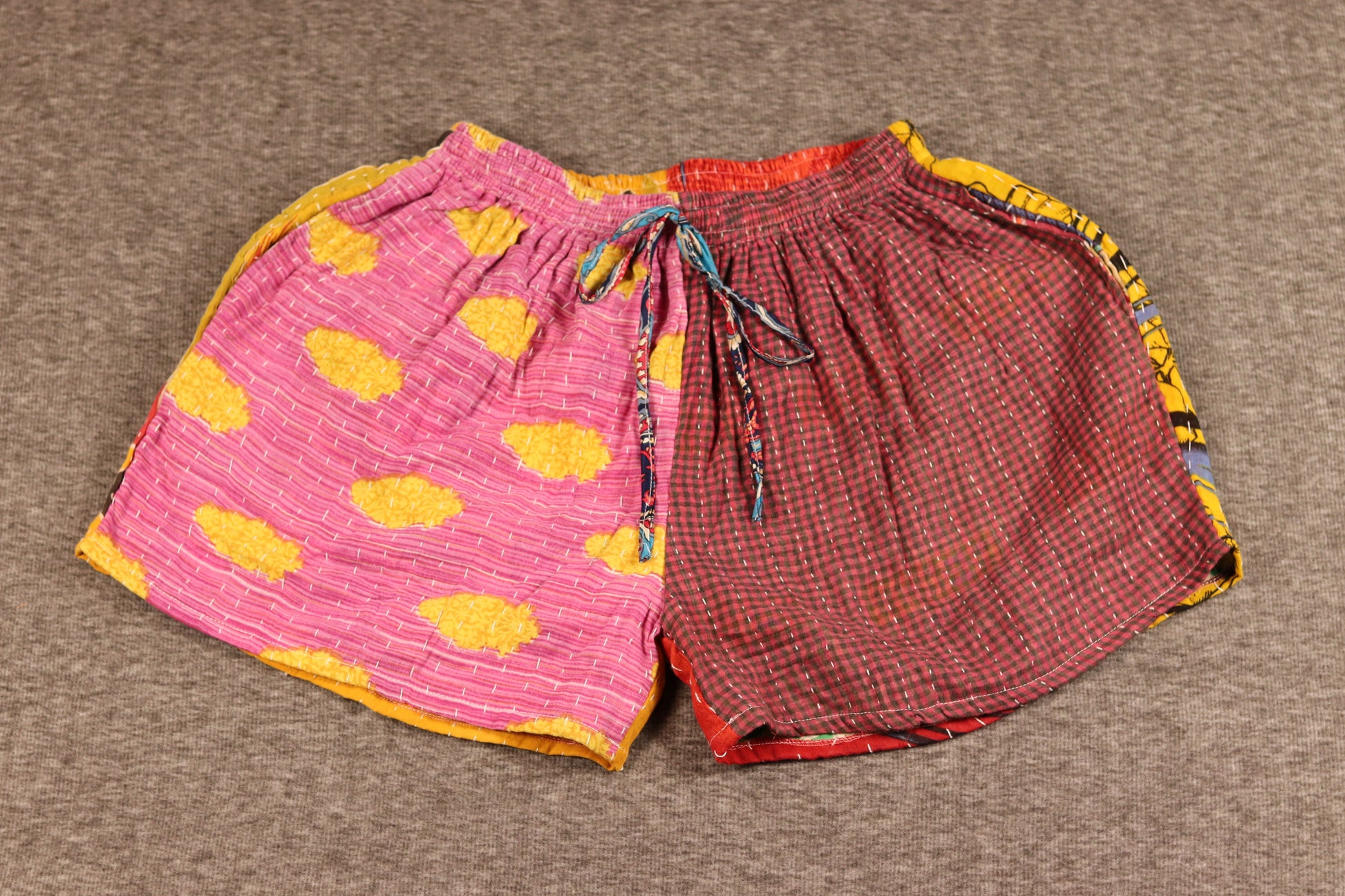 Unisex Kantha shorts with pink and yellow cotton and red gingham panels, detailed with Kantha stitching and a drawstring waist.