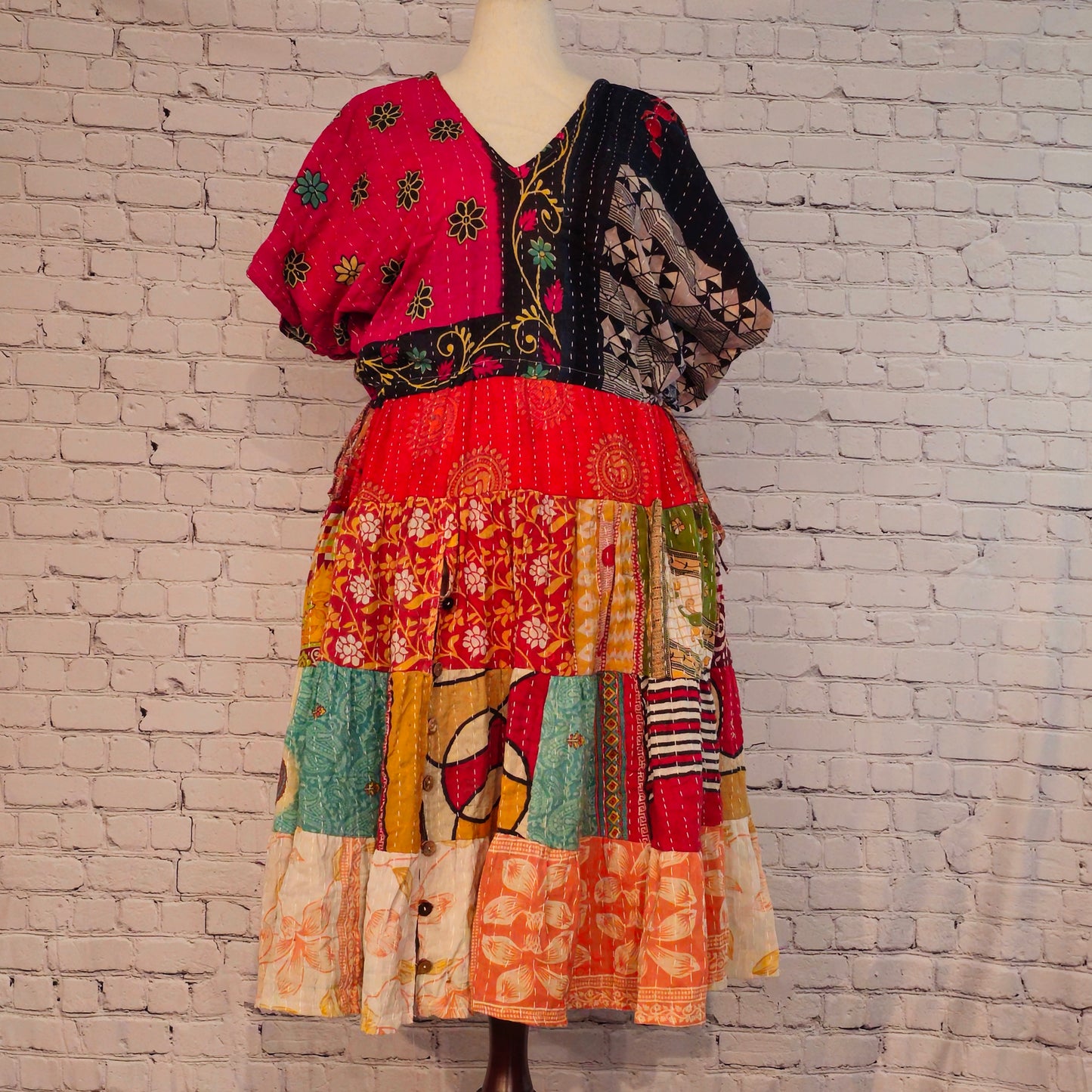 Twillow Midnight Bloom Kantha Midi Dress with pink and black floral bodice and multicolor patchwork skirt featuring Kantha stitching detail.