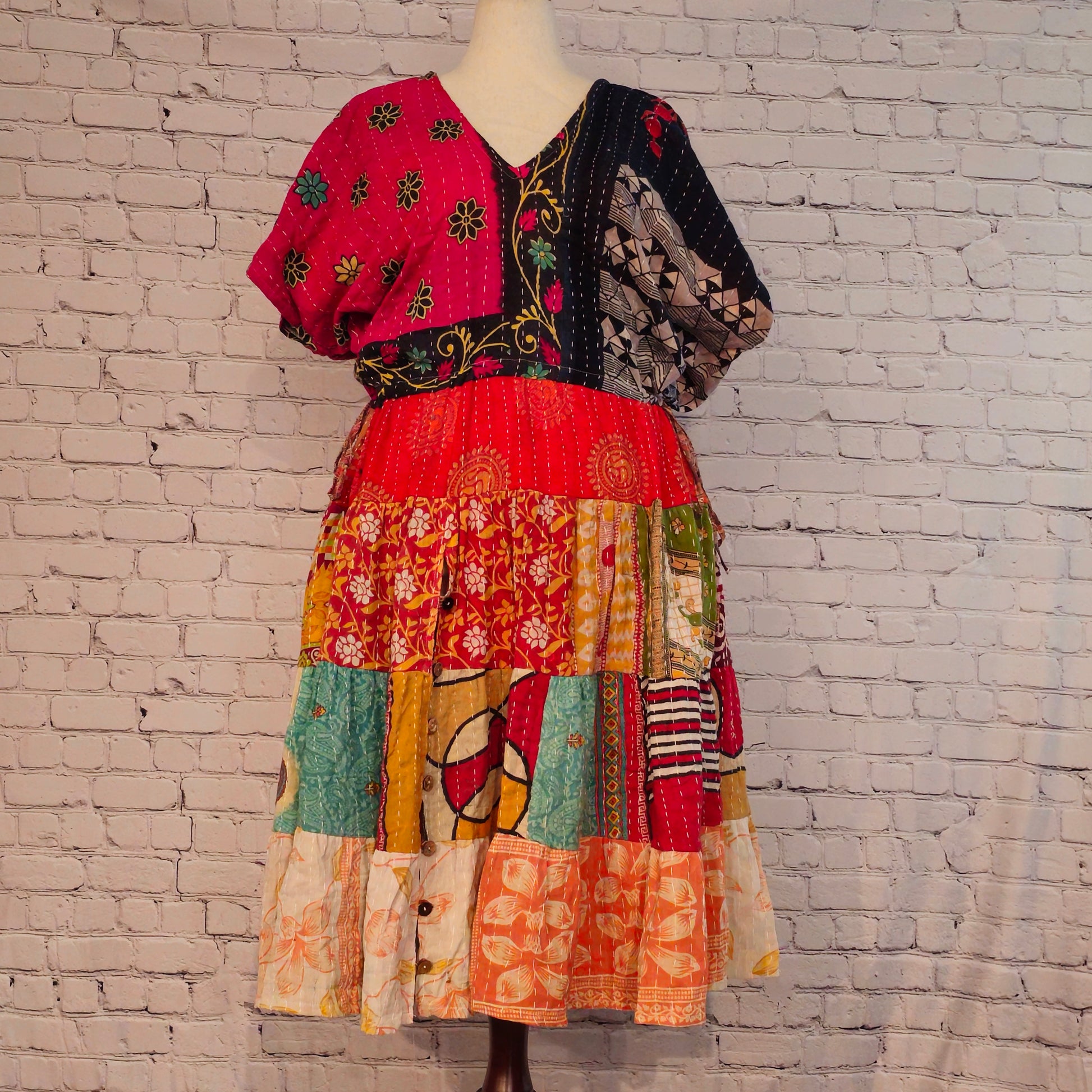 Twillow Midnight Bloom Kantha Midi Dress with pink and black floral bodice and multicolor patchwork skirt featuring Kantha stitching detail.