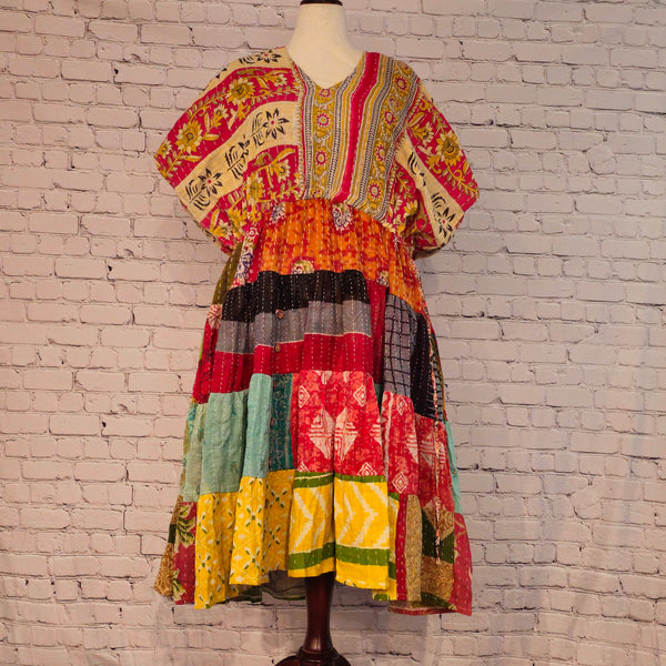 Twillow Sunfire Muse Kantha Midi Dress featuring floral yellow and pink bodice with multicolor patchwork skirt and Kantha stitching detail.