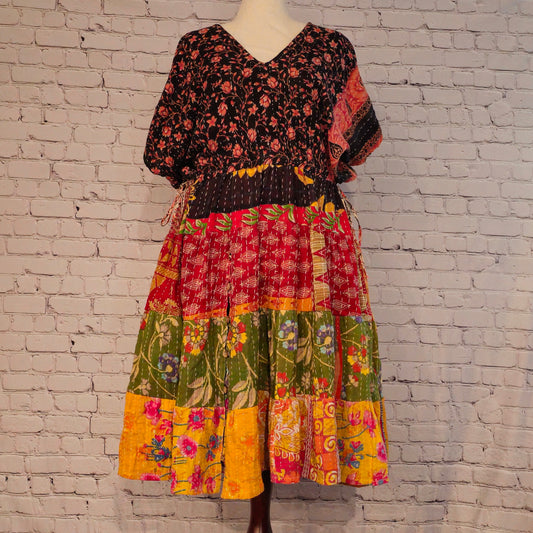 Twillow Wild Garden Kantha Midi Dress featuring a black floral bodice and multicolor floral patchwork skirt with Kantha stitching detail.