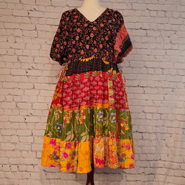 Twillow Wild Garden Kantha Midi Dress featuring a black floral bodice and multicolor floral patchwork skirt with Kantha stitching detail.