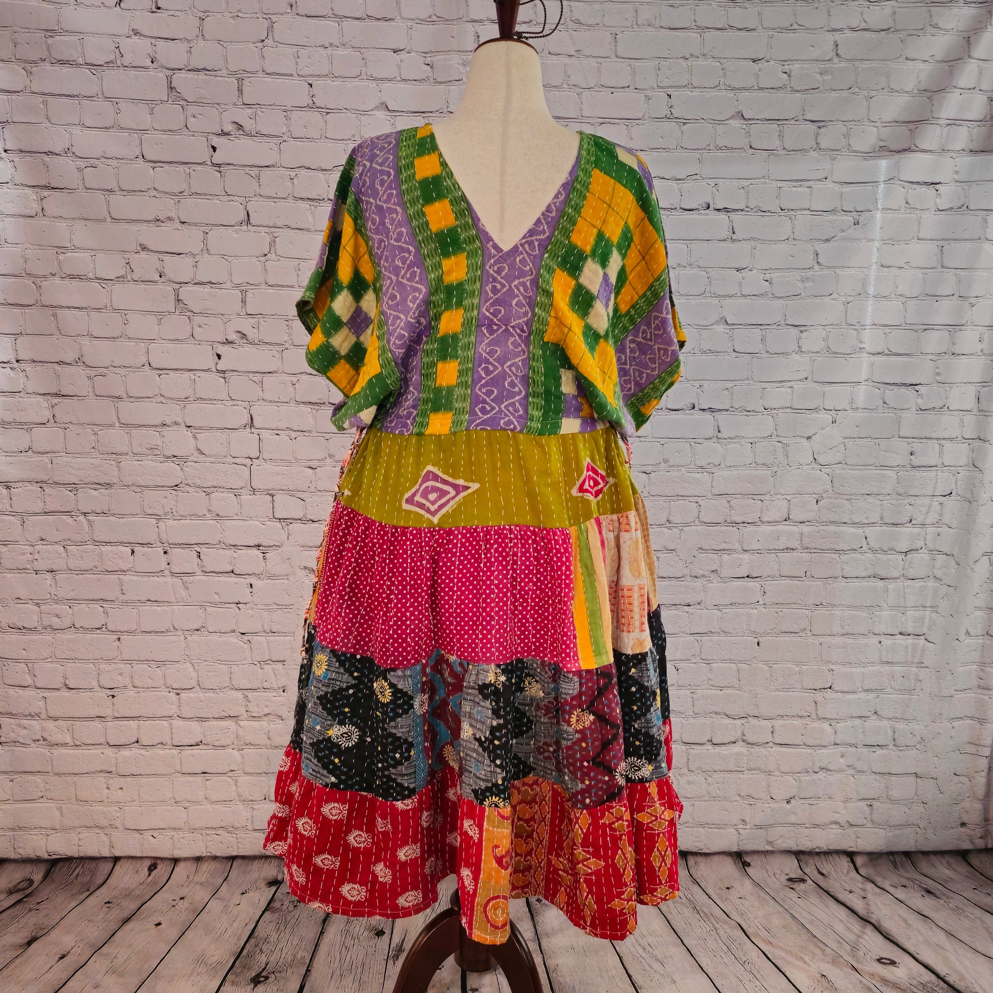 Twillow Spring Mosaic Kantha Midi Dress with green and lavender bodice and colorful patchwork skirt featuring Kantha stitching detail.