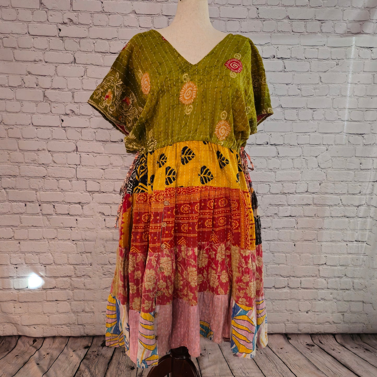 Twillow Harvest Glow Kantha Midi Dress with olive green bodice and warm yellow, red, and pink patchwork panels featuring Kantha stitching.