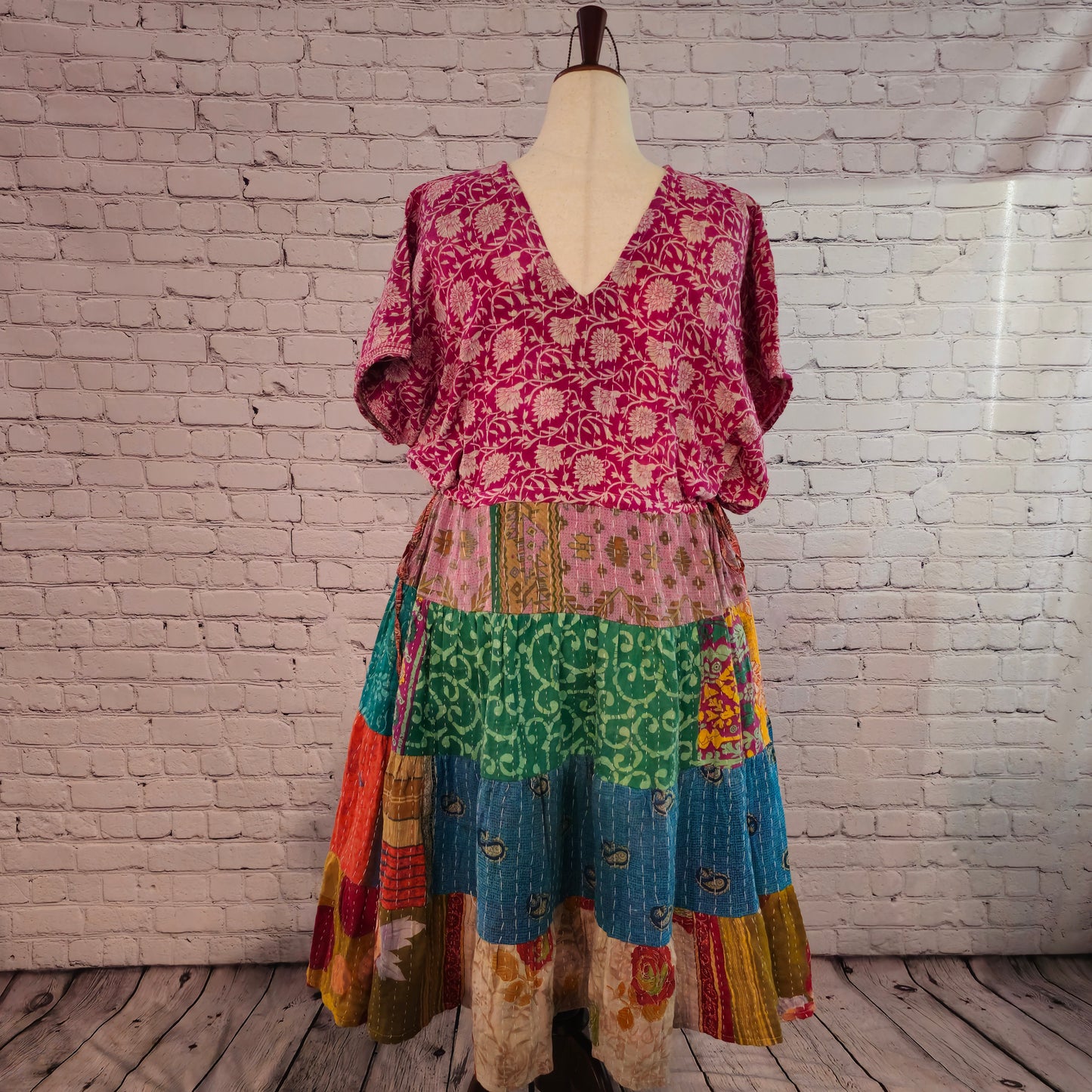 Twillow Sunset Bloom Kantha Midi Dress featuring magenta floral bodice and warm orange, turquoise, and gold patchwork skirt with Kantha stitching.
