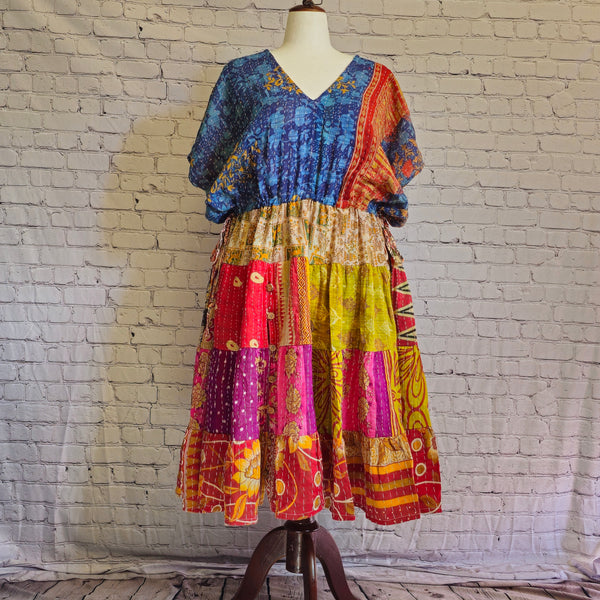 Twillow Ocean Sunrise Kantha Midi Dress featuring a blue bodice and bright multicolor patchwork skirt with Kantha stitching detail.