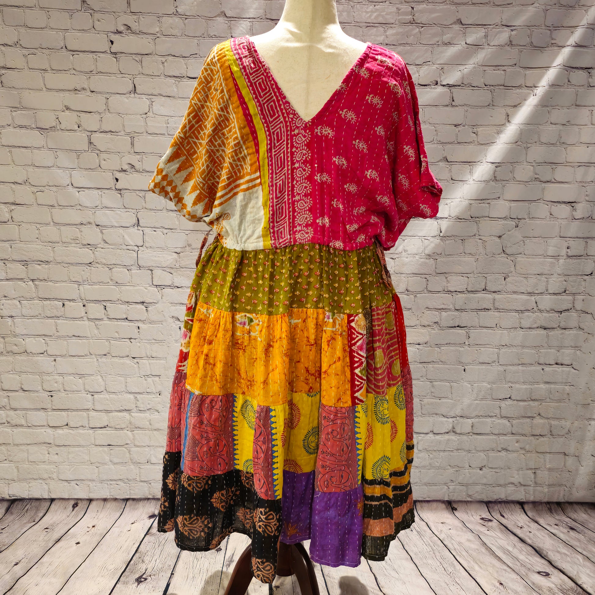 Twillow Festival Glow Kantha Midi Dress featuring pink and gold bodice with colorful patchwork skirt and traditional Kantha stitching.