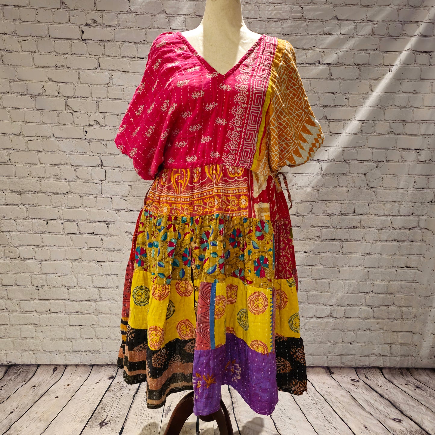 Twillow Festival Glow Kantha Midi Dress featuring pink and gold bodice with colorful patchwork skirt and traditional Kantha stitching.