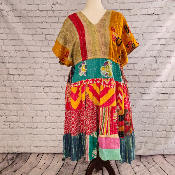 Twillow Sundara Glow Kantha Midi Dress featuring a golden-brown bodice and vivid coral, teal, and red patchwork skirt accented with Kantha stitching.