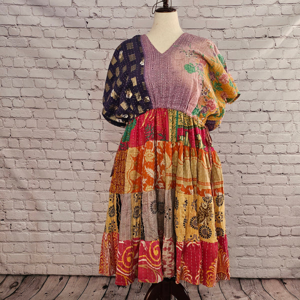 Twillow Moonlit Meadow Kantha Midi Dress featuring a lavender and navy mixed-pattern top with a vibrant boho patchwork skirt in orange, gold, red, and floral prints accented by Kantha stitching.