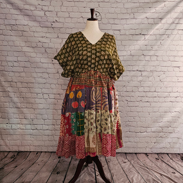 Twillow Forest Whimsy Kantha Midi Dress featuring an olive leaf-print top and a multi-color patchwork skirt in plum, sage, red, and gold accented by Kantha stitching.