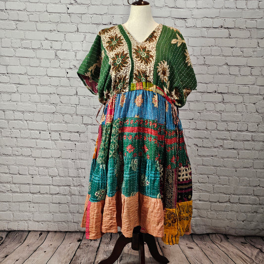 Twillow Forest Muse Kantha Midi Dress with green floral bodice and multicolor blue, teal, red, and peach patchwork skirt detailed with Kantha stitching.
