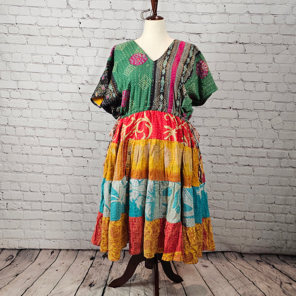 Green and magenta Twillow Emerald Sunburst Kantha Midi Dress with colorful yellow, teal, and red patchwork skirt and visible Kantha stitching.