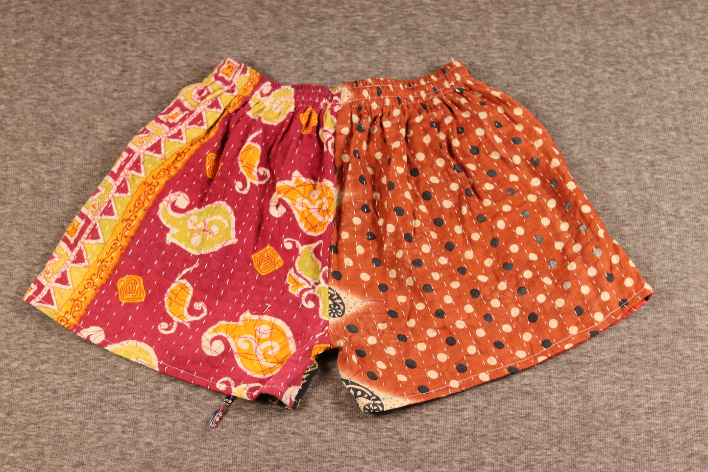 “Unisex Kantha shorts in red, orange, and black cotton, detailed with Kantha stitching and drawstring waist.”