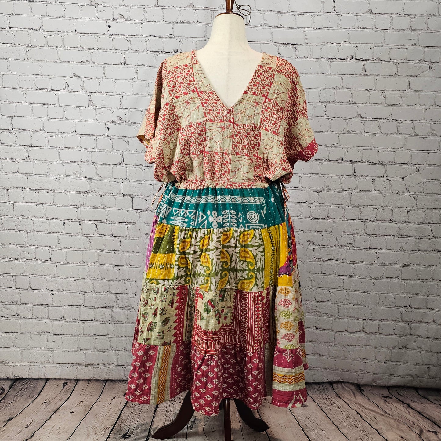 Rustic red and cream Twillow Woodland Patchwork Kantha Midi Dress with green, gold, and berry patchwork skirt and visible Kantha stitching.