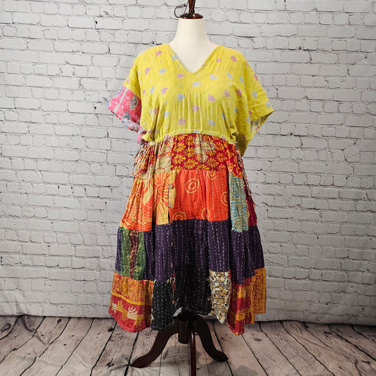 Bright citrus-colored Twillow Kantha Midi Dress with a yellow bodice and multicolor orange, plum, teal, and gold patchwork skirt featuring visible Kantha stitching.