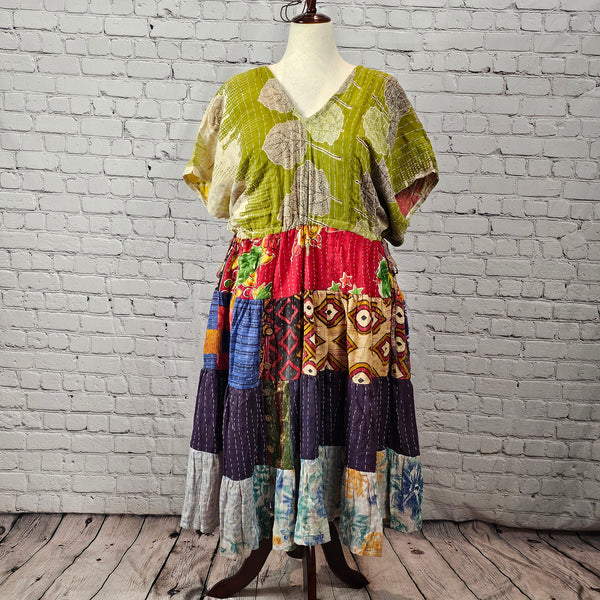 Olive-green leaf-print Twillow Kantha Midi Dress with a multicolor boho patchwork skirt featuring red, navy, blue, gold, and pastel panels with Kantha stitching.