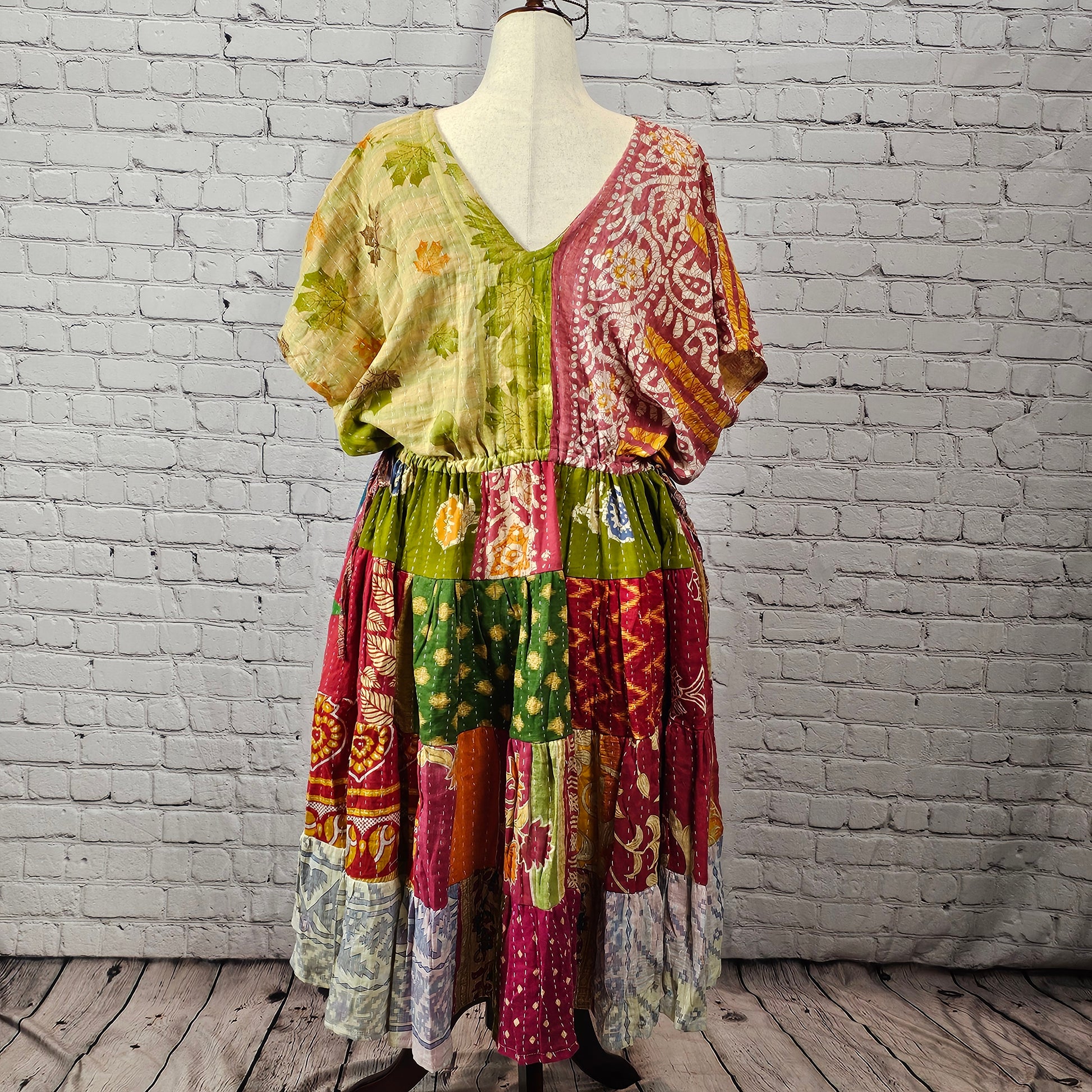 Pink and sage patchwork Twillow Kantha Midi Dress with a multicolor skirt in yellow, purple, magenta, orange, and blue, finished with Kantha stitching.