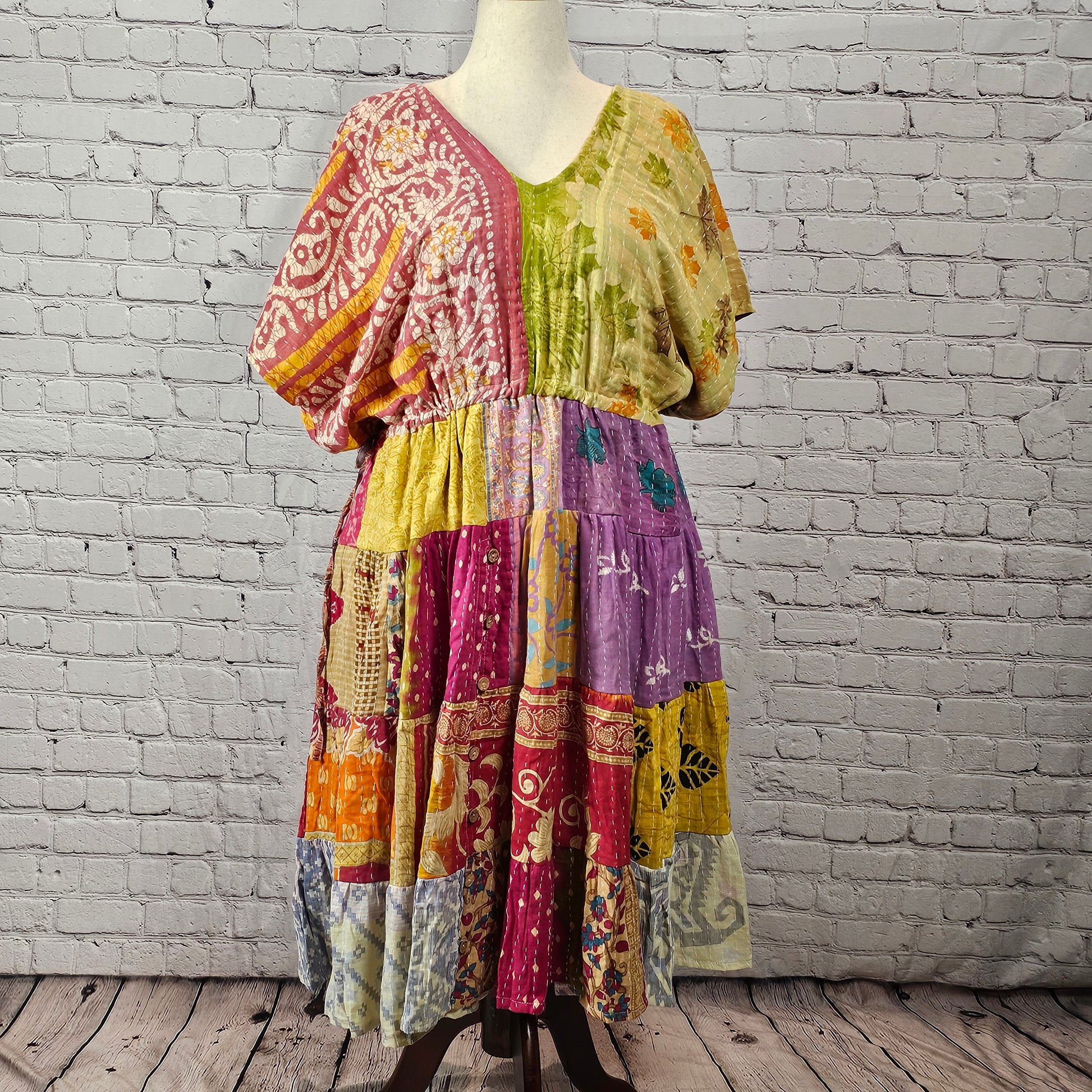 Pink and sage patchwork Twillow Kantha Midi Dress with a multicolor skirt in yellow, purple, magenta, orange, and blue, finished with Kantha stitching.