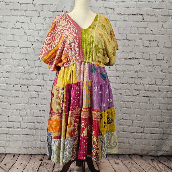 Pink and sage patchwork Twillow Kantha Midi Dress with a multicolor skirt in yellow, purple, magenta, orange, and blue, finished with Kantha stitching.