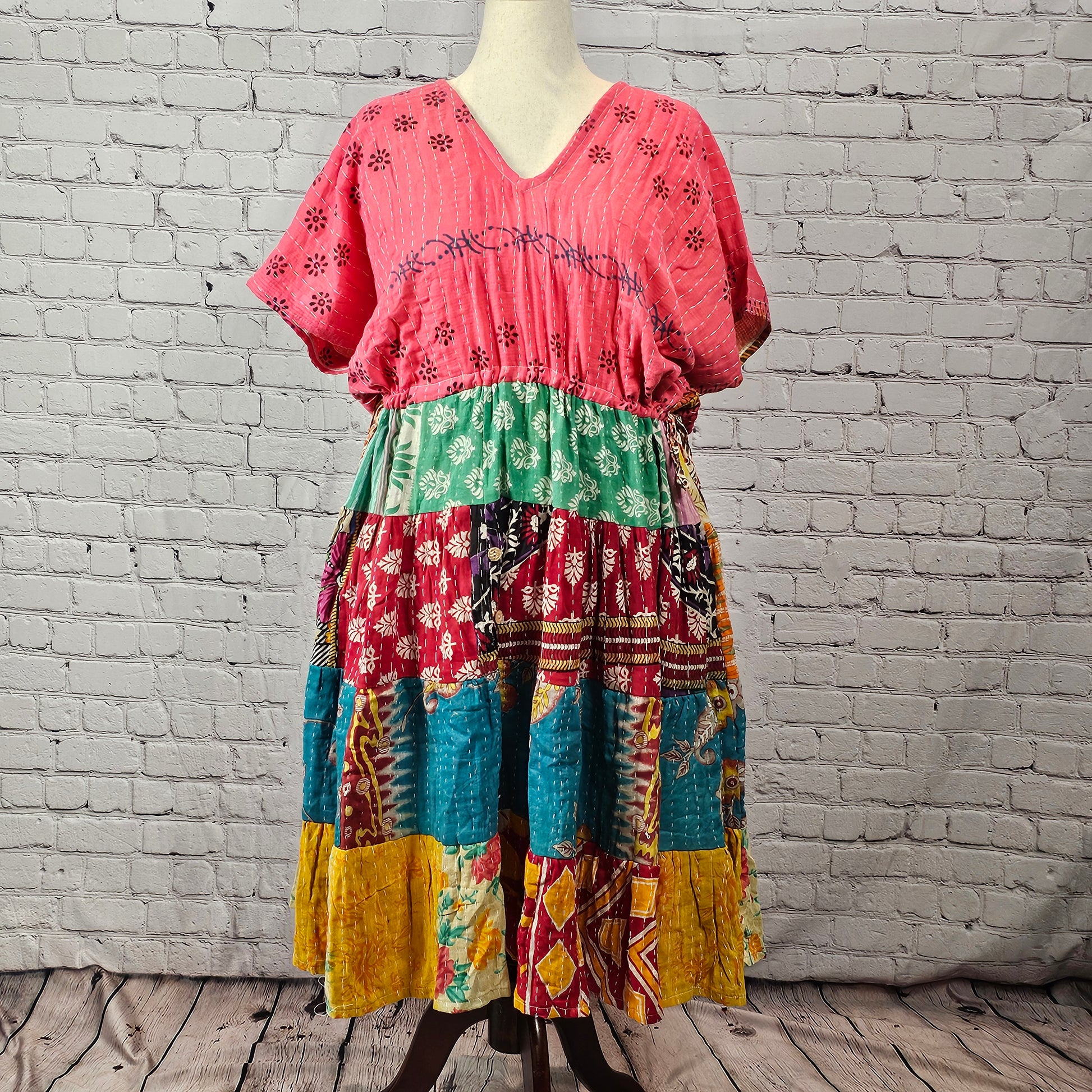 Berry pink Twillow Kantha Midi Dress with teal, maroon, mustard, and geometric patchwork tiers and visible Kantha stitching.
