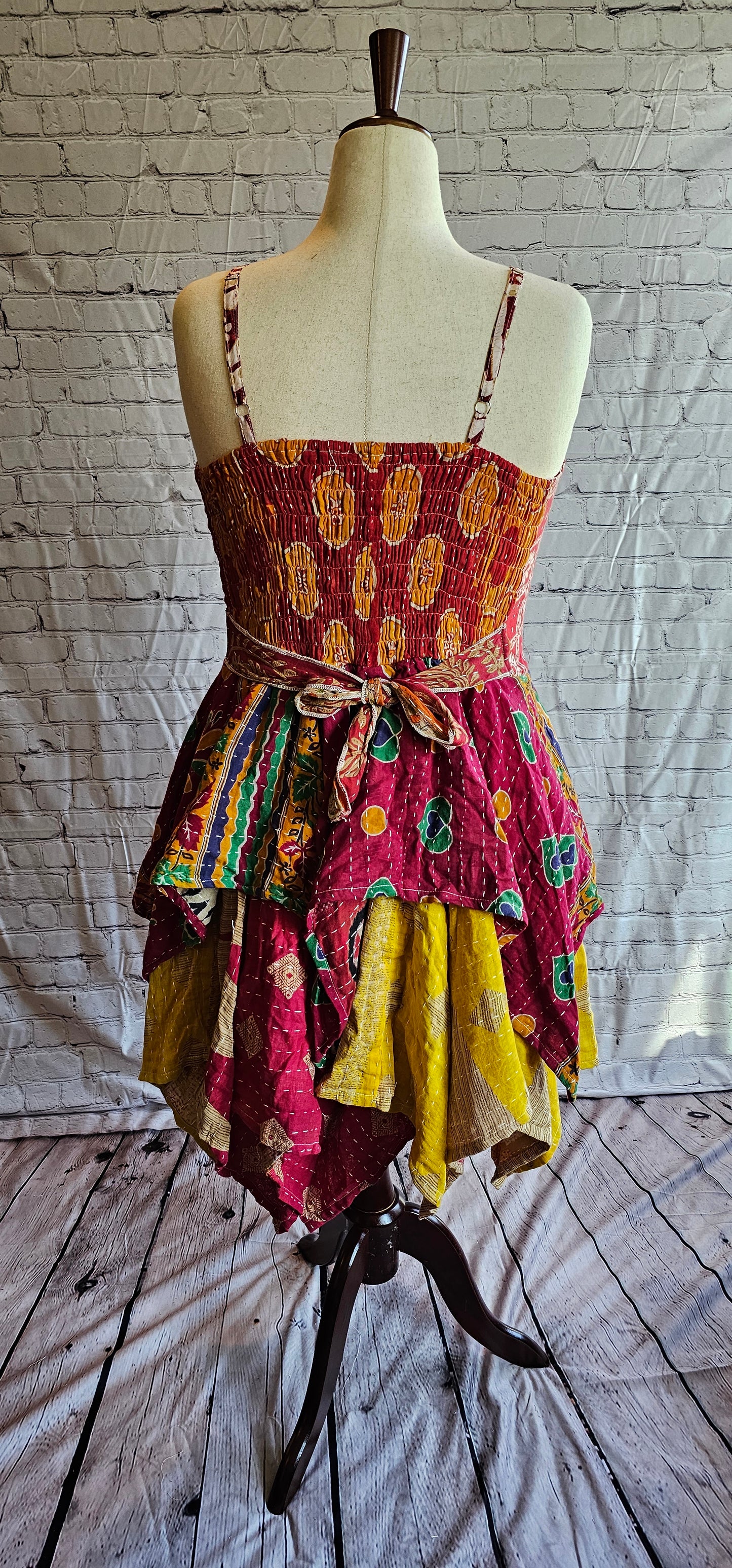 Krysta Kantha dress, back view highlighting bohemian patchwork and handkerchief hemline.