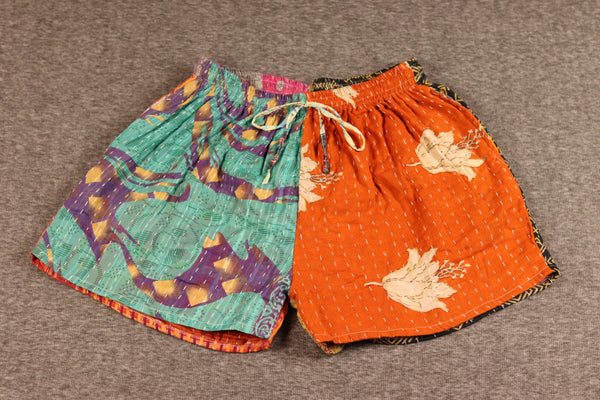 Unisex Kantha shorts with teal and orange cotton panels featuring floral and abstract patterns, detailed with Kantha stitching and drawstring waist.