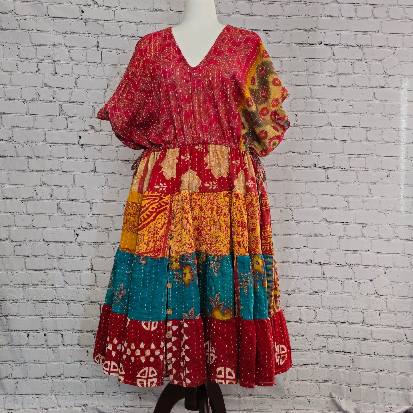 Twillow Crimson Sol Kantha Midi Dress with red, gold, and teal patchwork panels and Kantha stitching detail, featuring a relaxed boho fit.