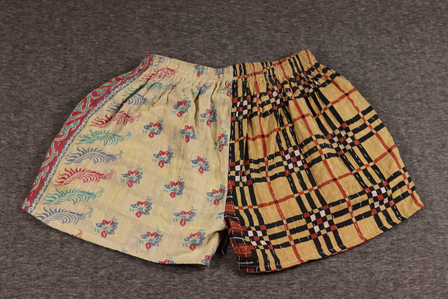 Unisex Kantha shorts with tan, magenta, and golden cotton panels featuring paisley and geometric prints, detailed with Kantha stitching and a drawstring waist.