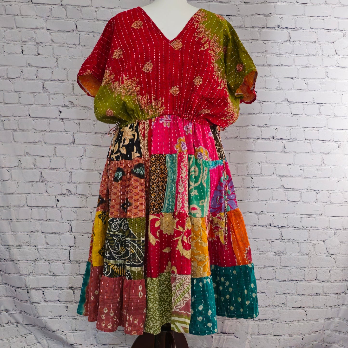 Twillow Solstice Bloom Kantha Midi Dress featuring olive-green and red bodice with multicolor patchwork skirt and Kantha stitching detail.