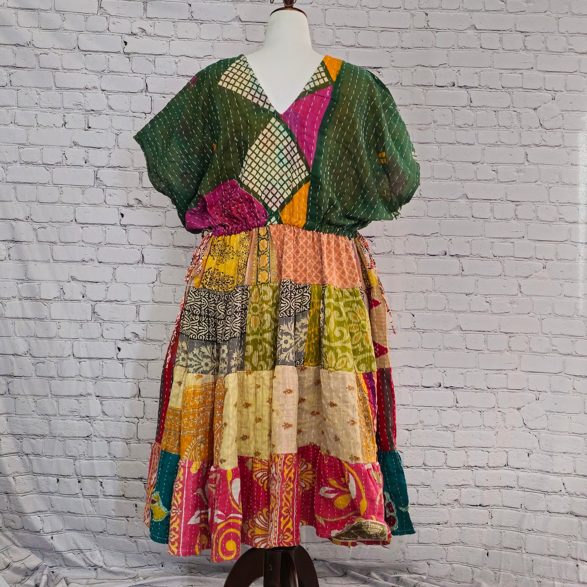 Twillow Verdant Muse Kantha Midi Dress featuring green geometric bodice and colorful patchwork skirt with Kantha stitching detail.