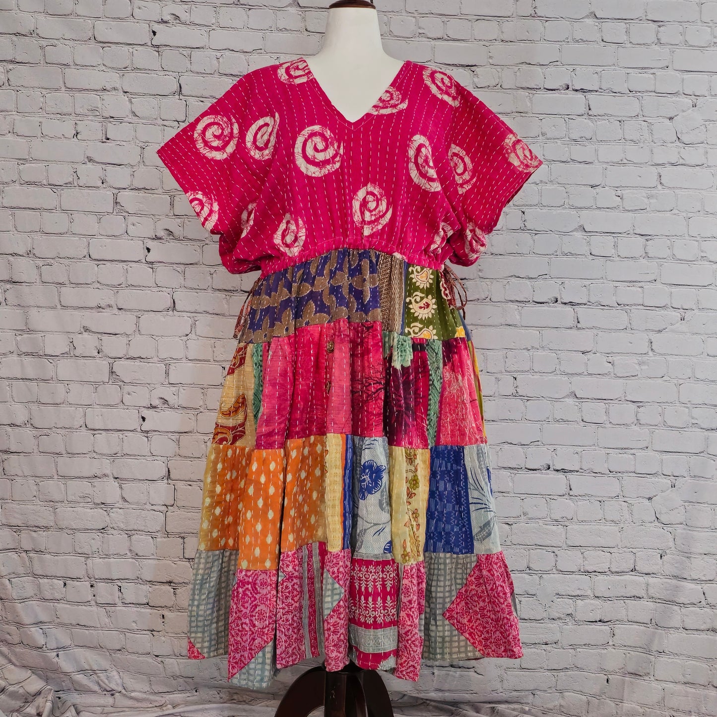 Twillow Fuchsia Bloom Kantha Midi Dress with bright pink swirl-patterned top and multicolor patchwork skirt featuring Kantha stitching.