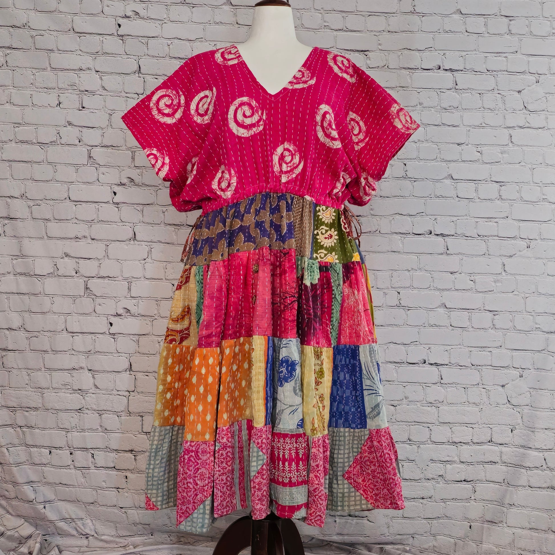 Twillow Fuchsia Bloom Kantha Midi Dress with bright pink swirl-patterned top and multicolor patchwork skirt featuring Kantha stitching.