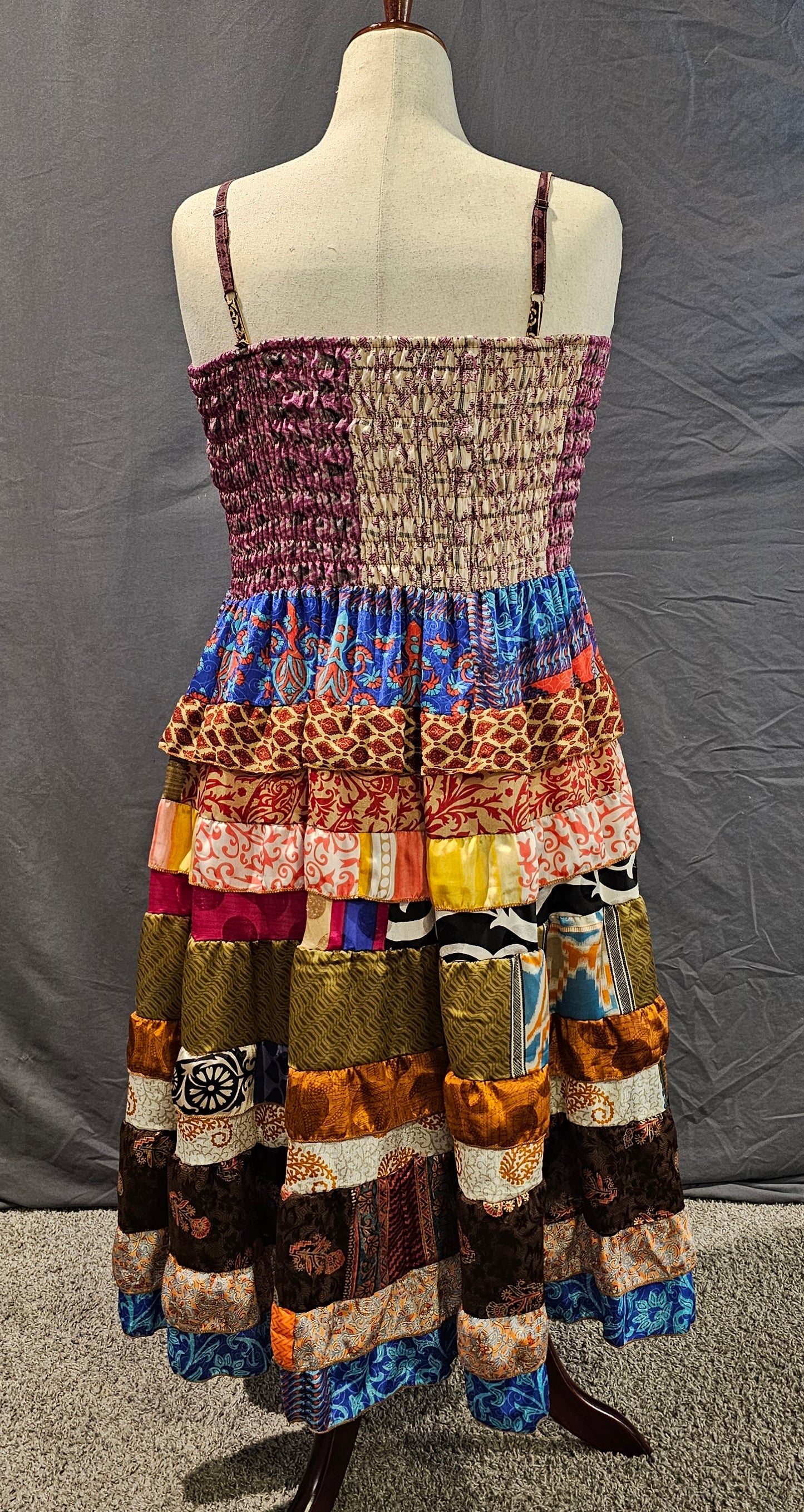 Upcycled sari dress in vibrant colors, part of Wild Kantha’s artisan clothing collection.